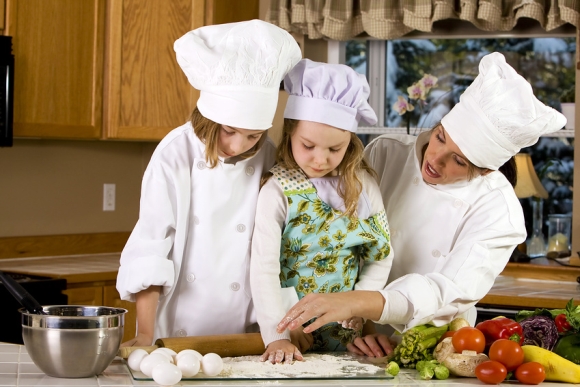 Mother teaching children how to cook